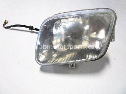 Used 2009 Kawasaki Teryx 750 LE OEM part # 23007-0113 left head light for sale